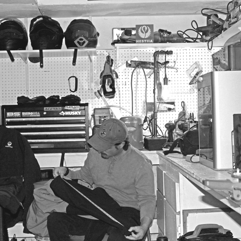 Person sitting in a workshop with tools and equipment in the background