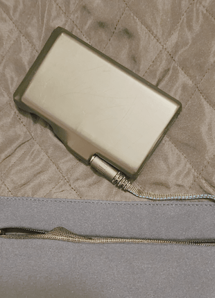 Image showing a battery connected to the Jacket's heating system via the connector in the interior jacket battery storage pocket.