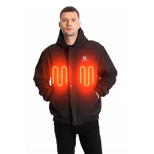 Man wearing a charcoal colored Hestiia heated jacket with the front panel heating zones graphically depicted. The heated jacket is hooded, with a snap-up storm flap and ribbed knit hem.