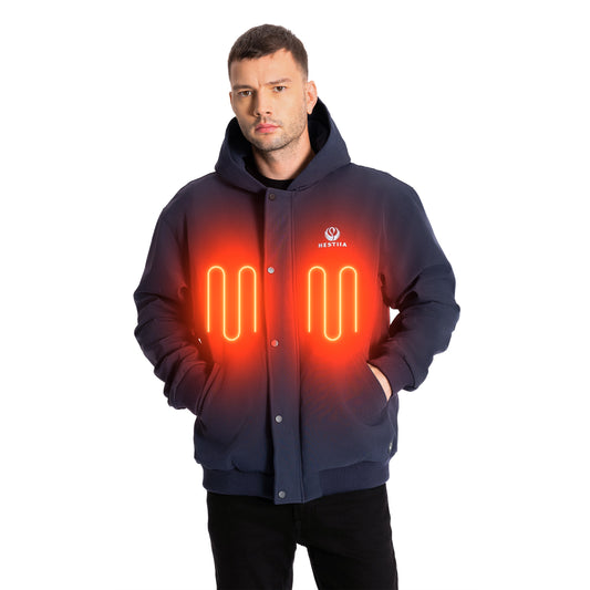 Man wearing a dark blue Hestiia heated jacket with the front panel heating zones graphically depicted. The heated jacket is hooded, with a snap-up storm flap and ribbed knit hem.