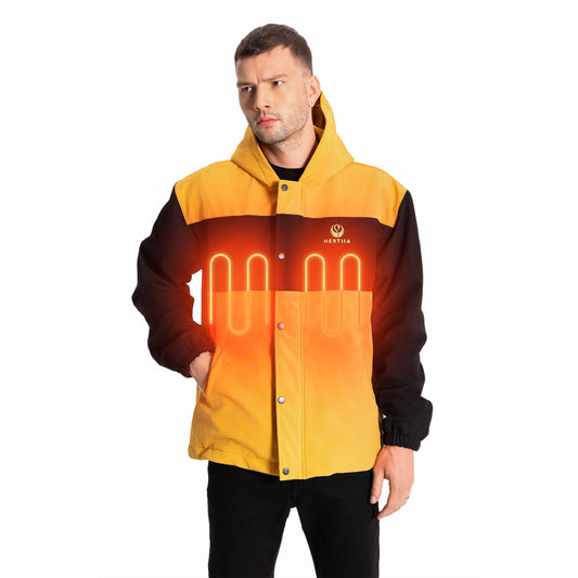 A man wearing an amber and black Hestiia heated jacket with integrated glowing orange heating coils depicting the heating zones on either side of the chest. The jacket is hooded, has elastic hem, a snap-up storm flap, and a visible Hestiia logo on the left chest.